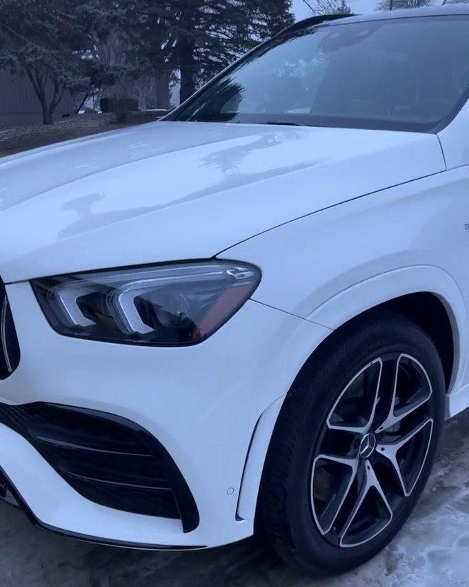 A white Mercedes-AMG GLE outdoors, AMG grille and alloy wheels, whole car in frame.